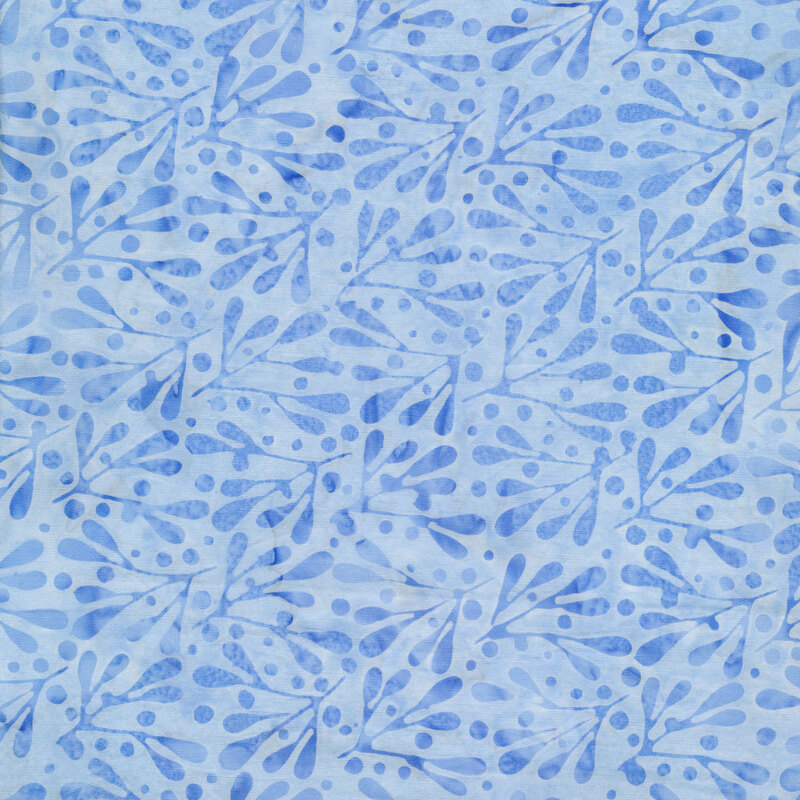 Light blue mottled fabric with tonal dots and twigs with leaves all over