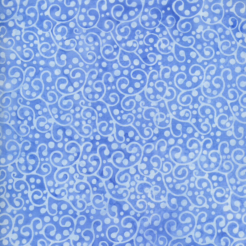 Medium blue mottled fabric with pale blue swirls and dots all over