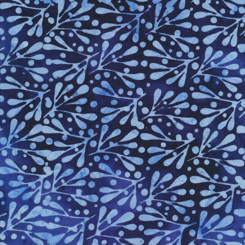 dark and medium blue mottled fabric with light tonal dots and twigs with leaves all over