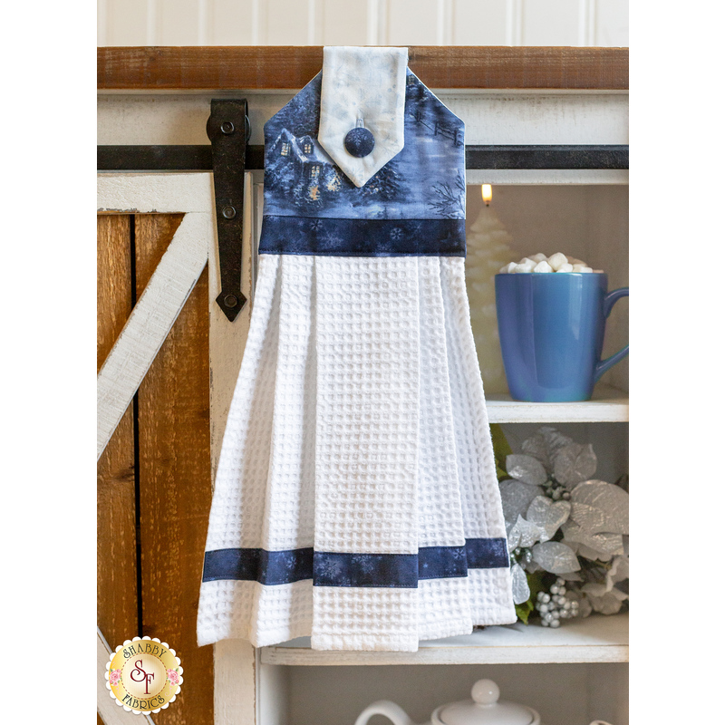 Blue and white quilted towel using the Blizzard Blues fabric collection hanging from a farmhouse style shelf 