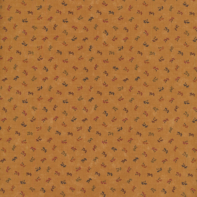 dusty orange fabric with simple and small multicolor flowers dotted across it