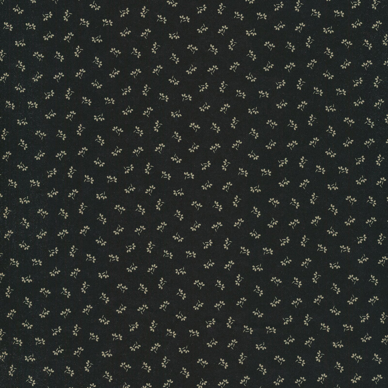 black fabric with small beige flowers dotted across it.