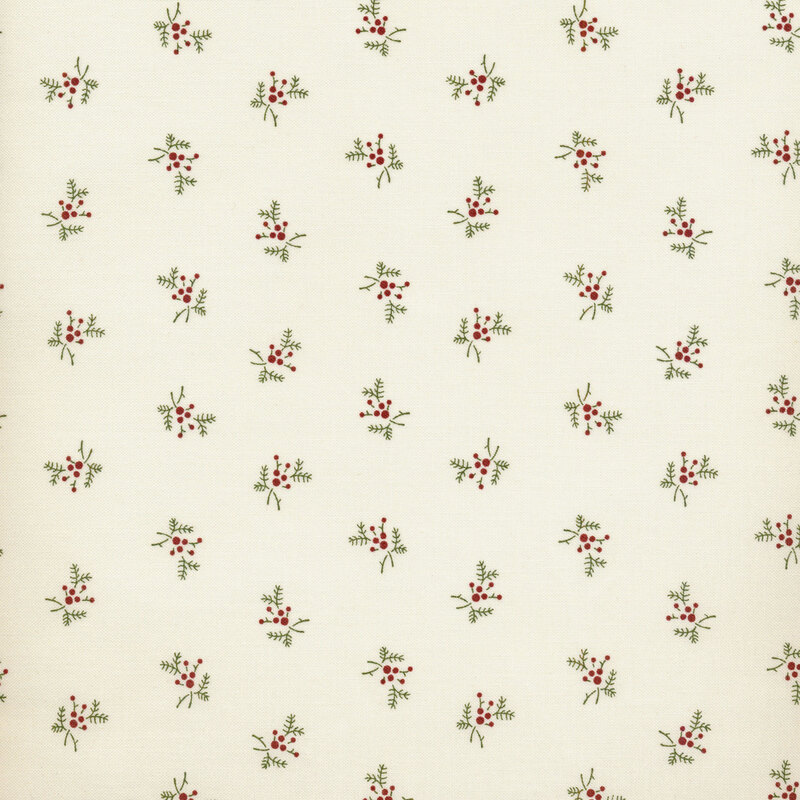 red and green holly sprigs tossed on a cream background