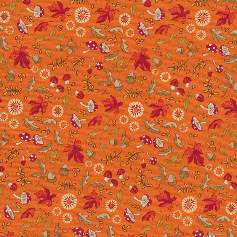 Bright orange fabric with red maple leaves, mushrooms, acorns, flowers and other fun motifs