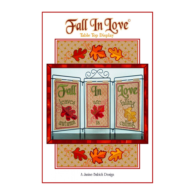 Front of fall in love table top display pattern featuring embroidered leaves and the phrase 
