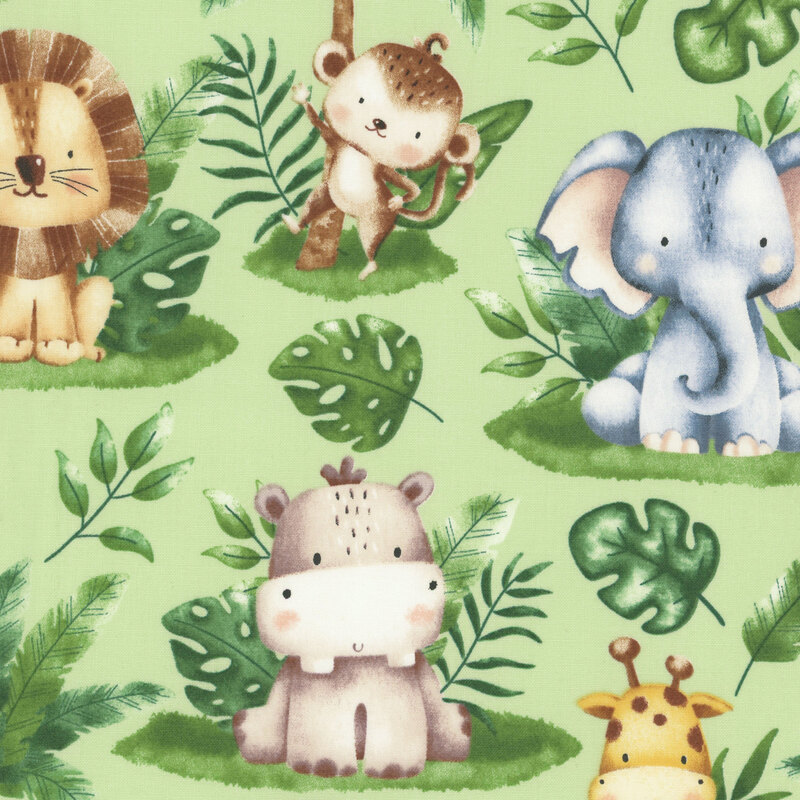 fabric of safari animals and leaves on a light sage green background