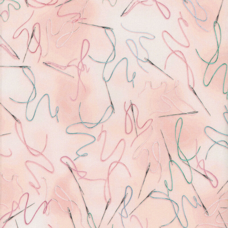 Pale pink mottled fabric with threaded needles tossed all over with different thread colors strewn around them