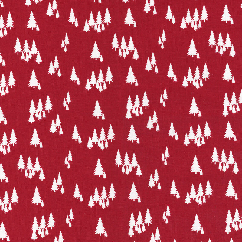 fabric featuring white pine trees on a solid red background