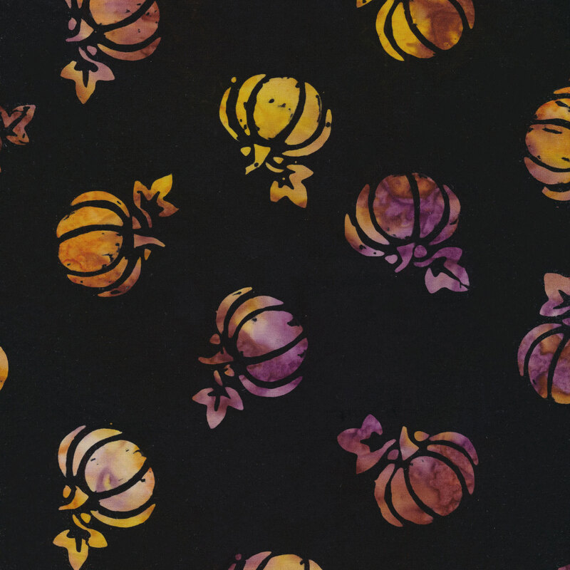 black fabric with tossed pumpkins spaced evenly apart with an orange and purple mottled watercolor look