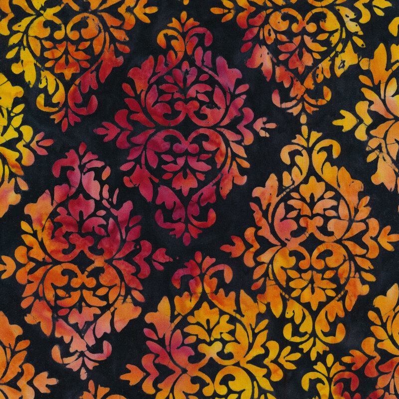 Black fabric with damask patterns mottled with orange, pink, and purple
