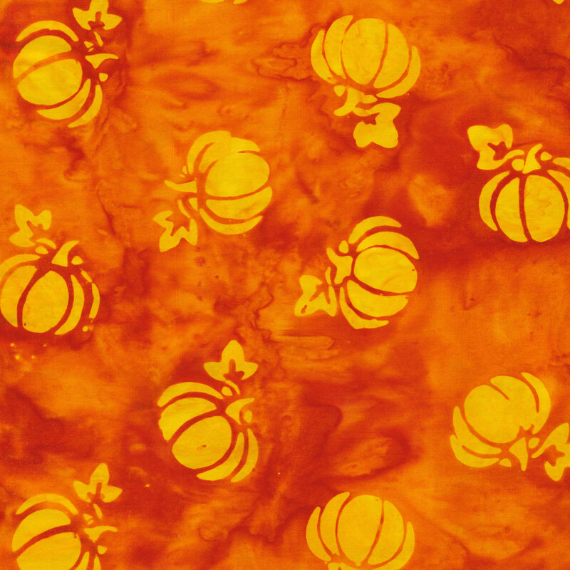 bright orange mottled fabric with tossed pumpkins spaced evenly apart with a yellow mottled watercolor look