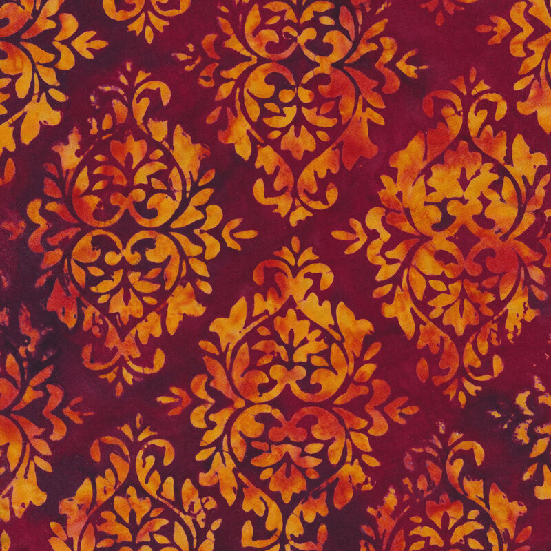 Bright pink and purple mottled fabric with damask patterns mottled with shades of orange and red