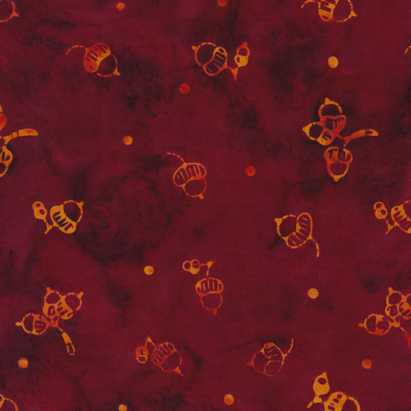 maroon mottled fabric with small acorns and dots spaced unevenly apart with a red and yellow mottled watercolor look