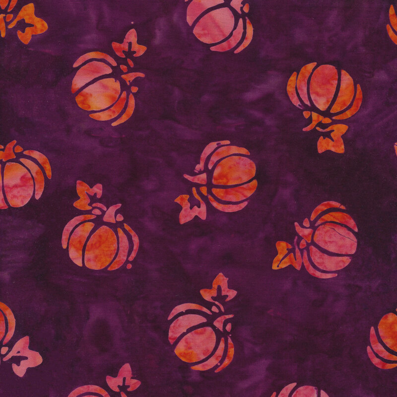 purple mottled fabric with tossed pumpkins spaced evenly apart with a pink and orange mottled watercolor look