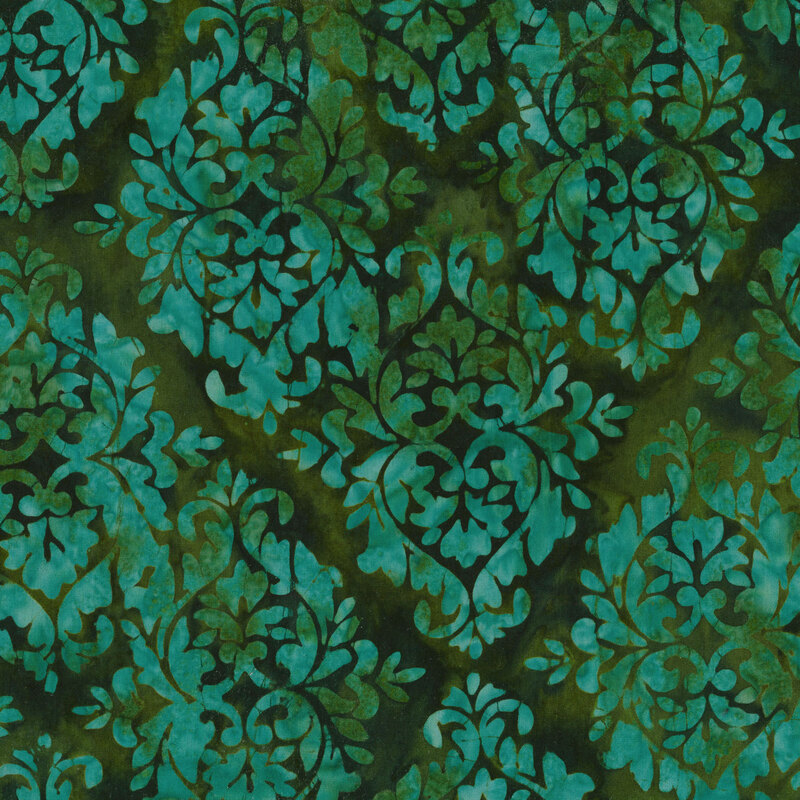 green mottled fabric with damask patterns mottled with shades of teal