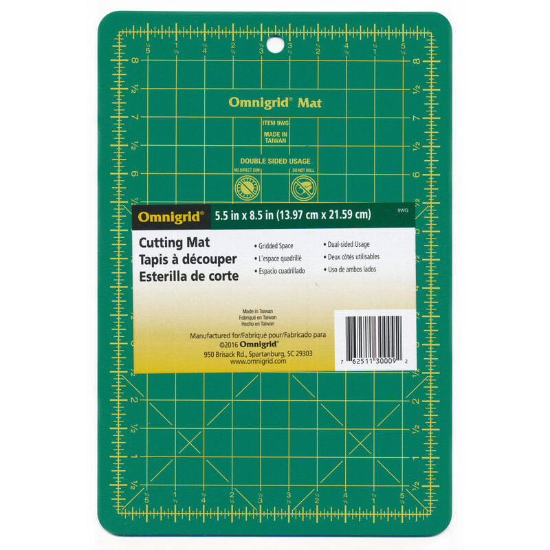 Green omnigrid cutting mat with perpendicular lines measuring up to 6 inches horizontally and 9 inches vertically