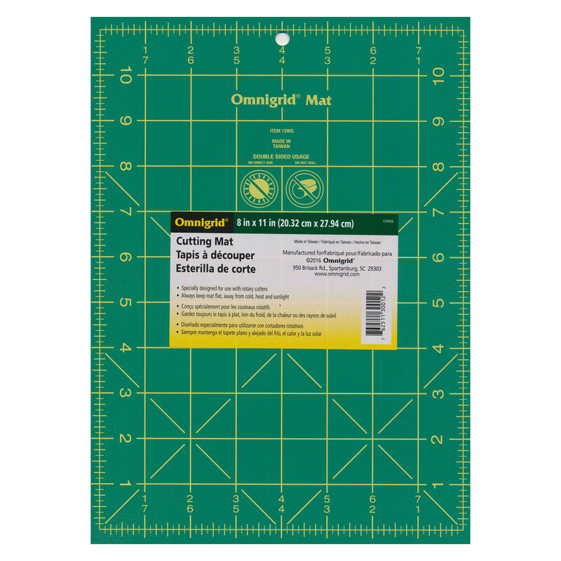 Green omnigrid cutting mat with perpendicular lines measuring up to 8 inches horizontally and 11 inches vertically