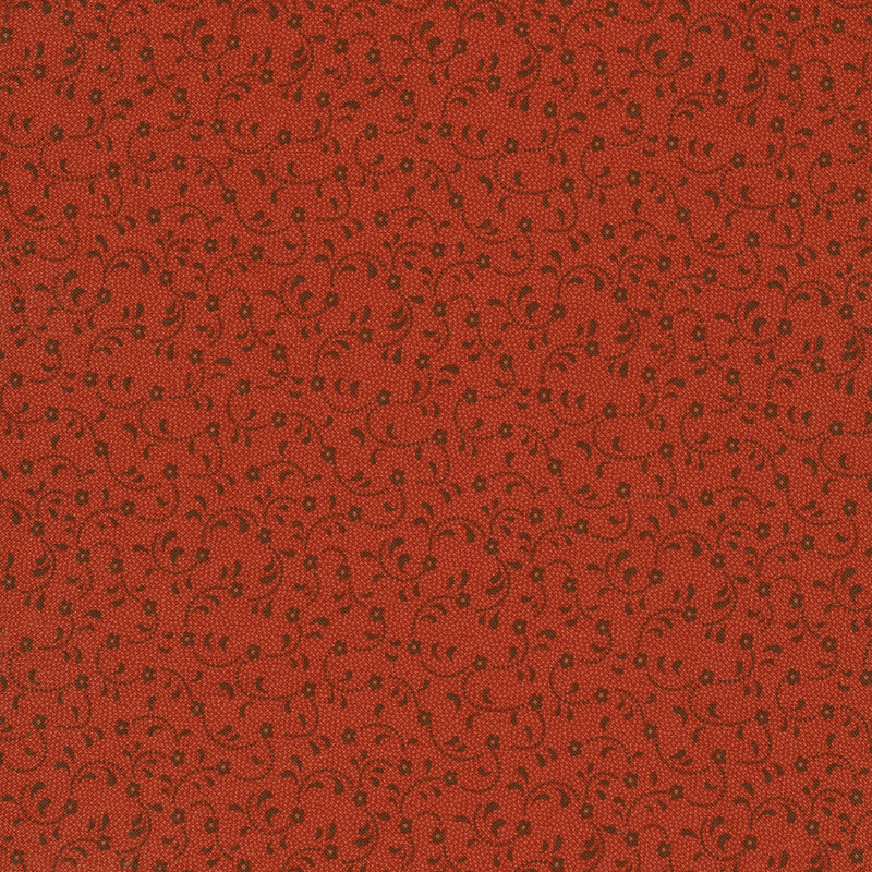 orange-red tonal fabric with flowers swirling across it