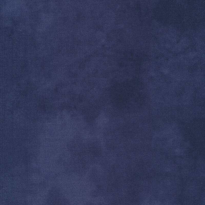 Solid tonal dark blue fabric with mottling all over