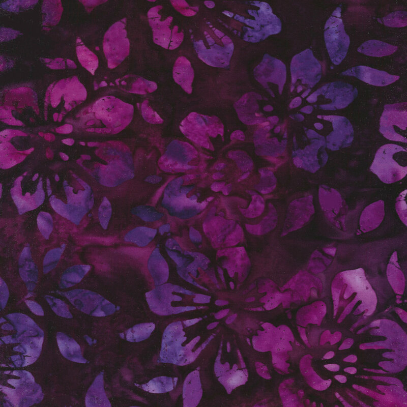 Fabric with pink and purple mottled flowers on a dark magenta background
