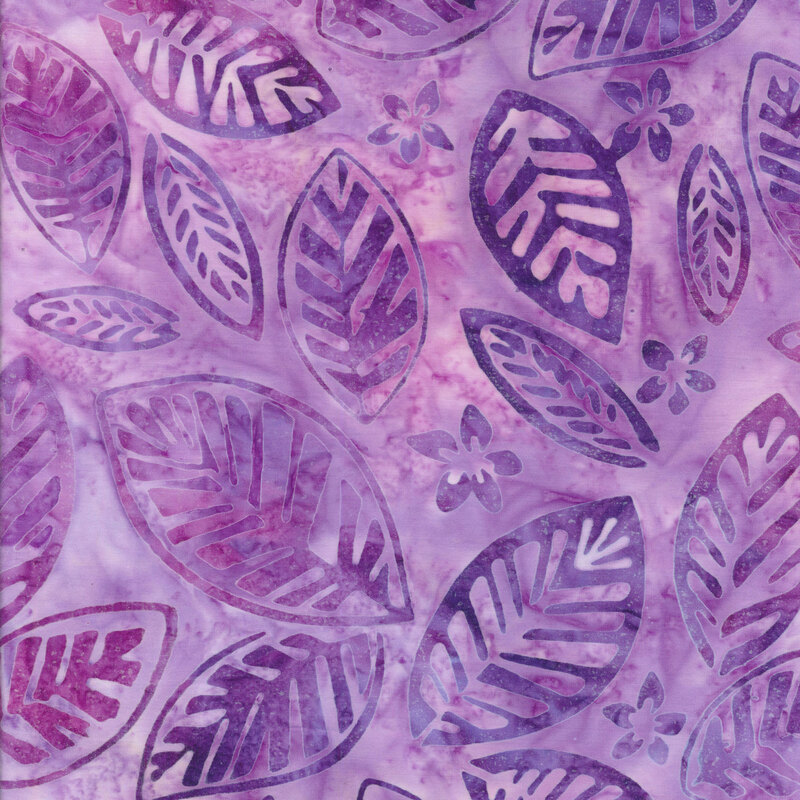 Fabric with purple and pink tossed banana leaves on a light purple mottled background