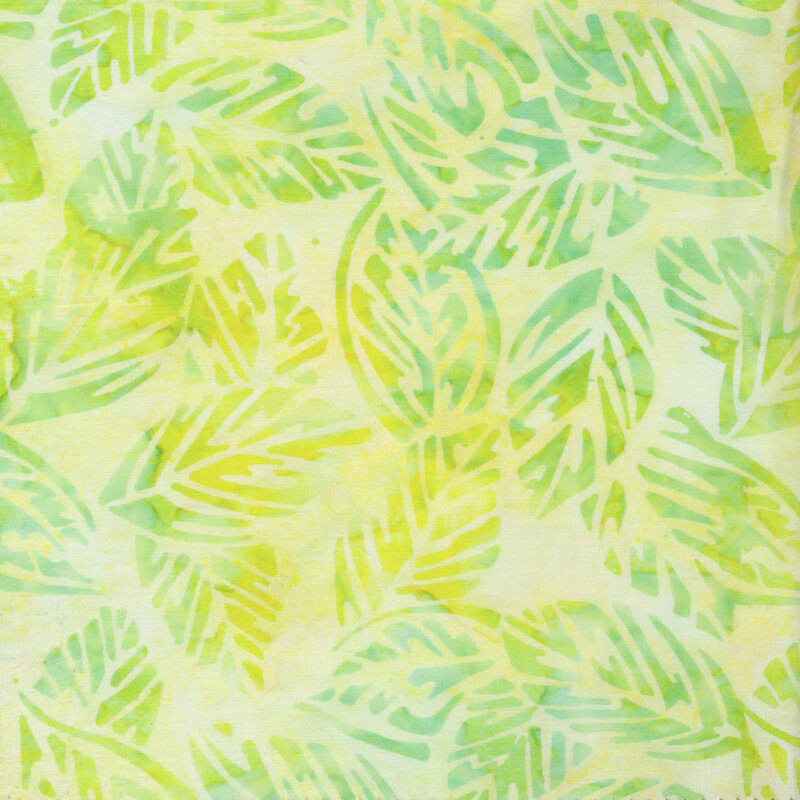 Fabric with green and yellow leaves on a light lemon yellow background