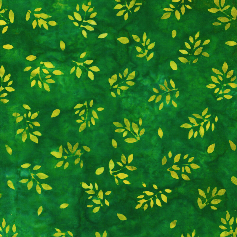 Fabric with yellow-green tossed branches with leaves on a dark green mottled fabric