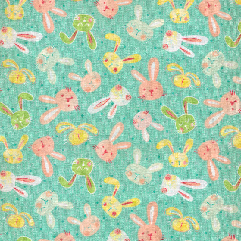 Teal fabric with tiny tonal dots and tossed stylized bunny heads in light blue, white, yellow, pink, and green