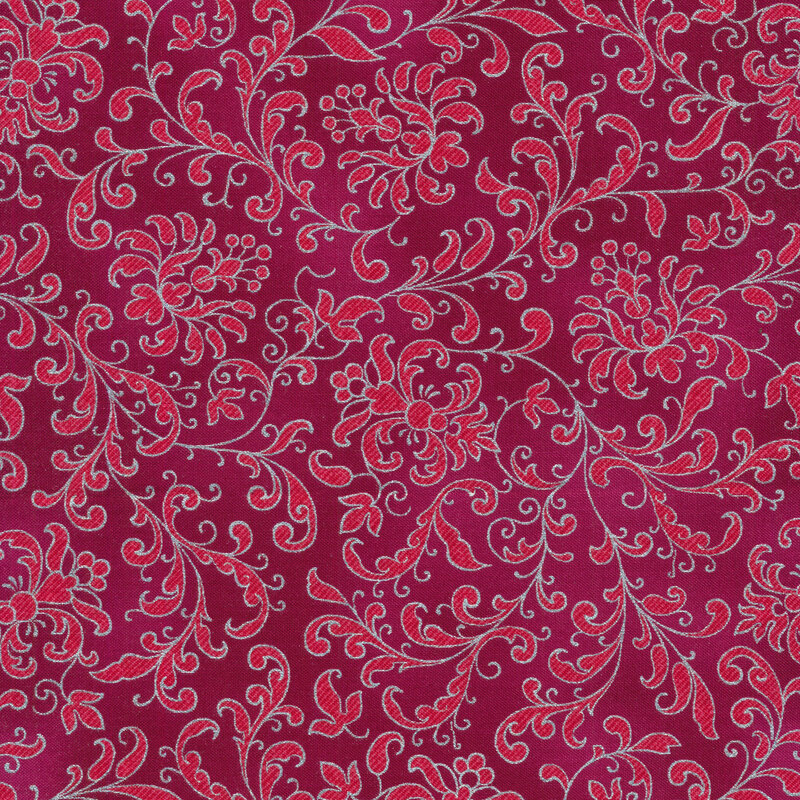dark pink mottled fabric with hot pink floral filigree and swirls all over, edged with silver metallic accents