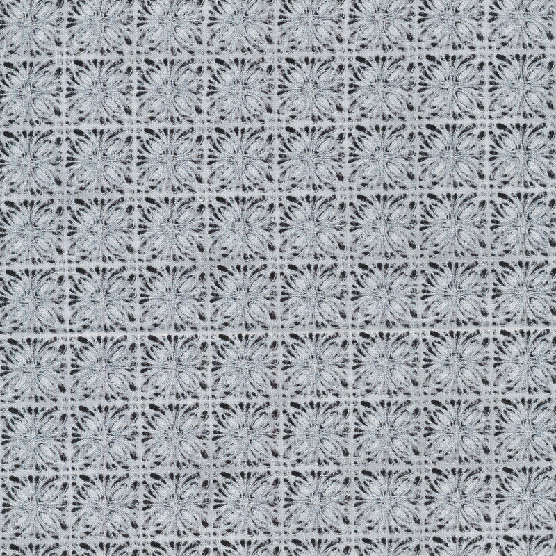 Gray fabric with kaleidoscopic square designs in silver and black stacked closely together