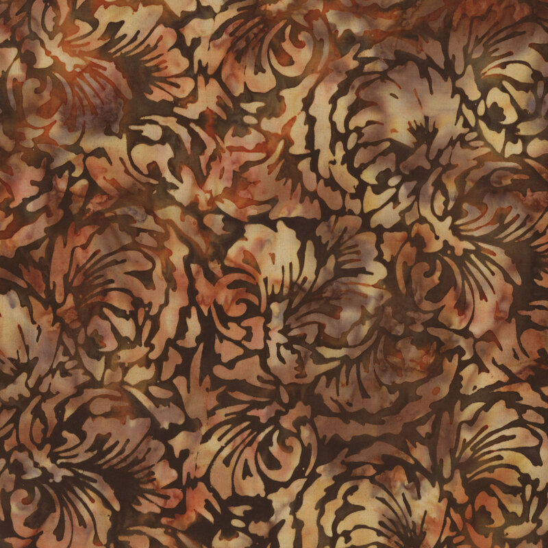 Scan of brown mottled batik fabric with abstract floral patterning on a black background 