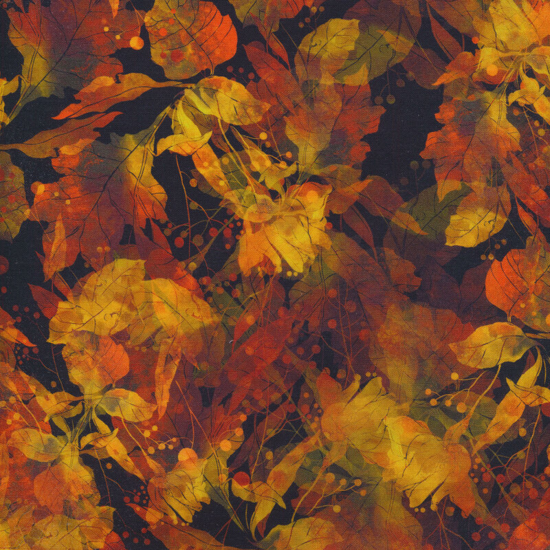 black fabric covered in autumn leaves ranging in shape and color