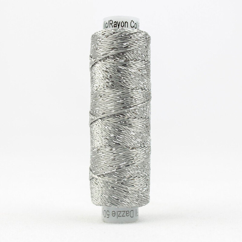 A spool of WonderFil Dazzle DZ6103 Silver thread on a white background