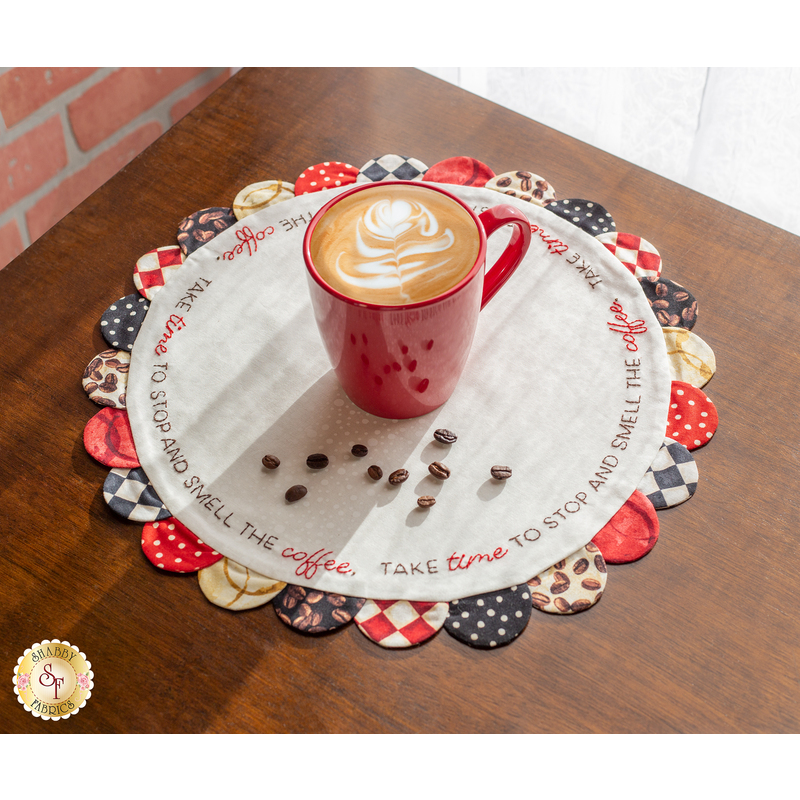 An image of a Scalloped Table Topper in Coffee Always styled on a brown table.