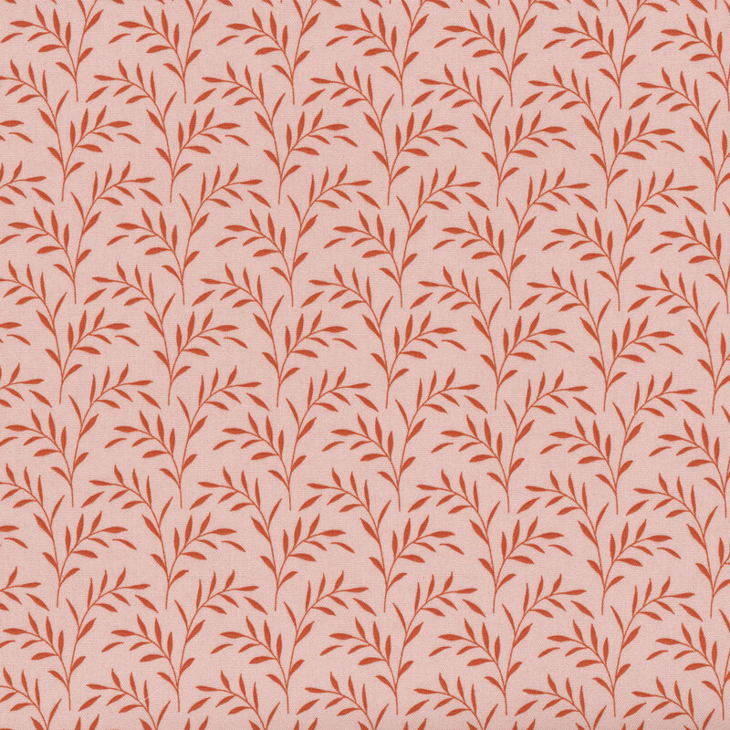 Pink fabric with red olive branches and leaves scattered across it