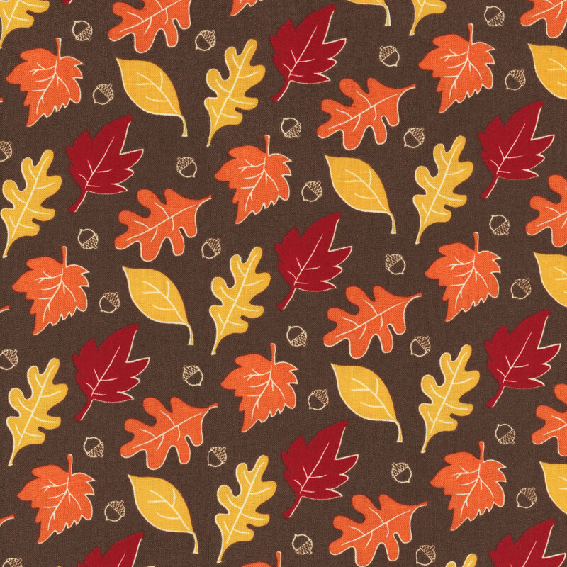 fabric featuring orange, yellow and red leaves and acorns on a rich brown background