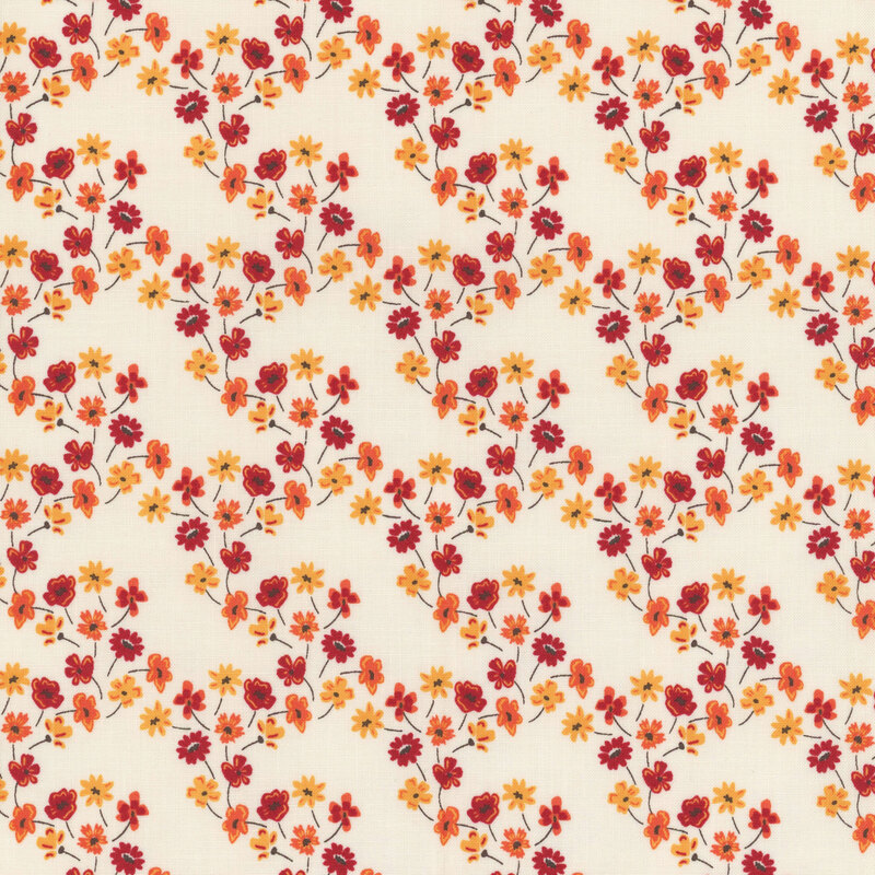 fabric with orange, yellow and red flowers forming a lattice across a cream background