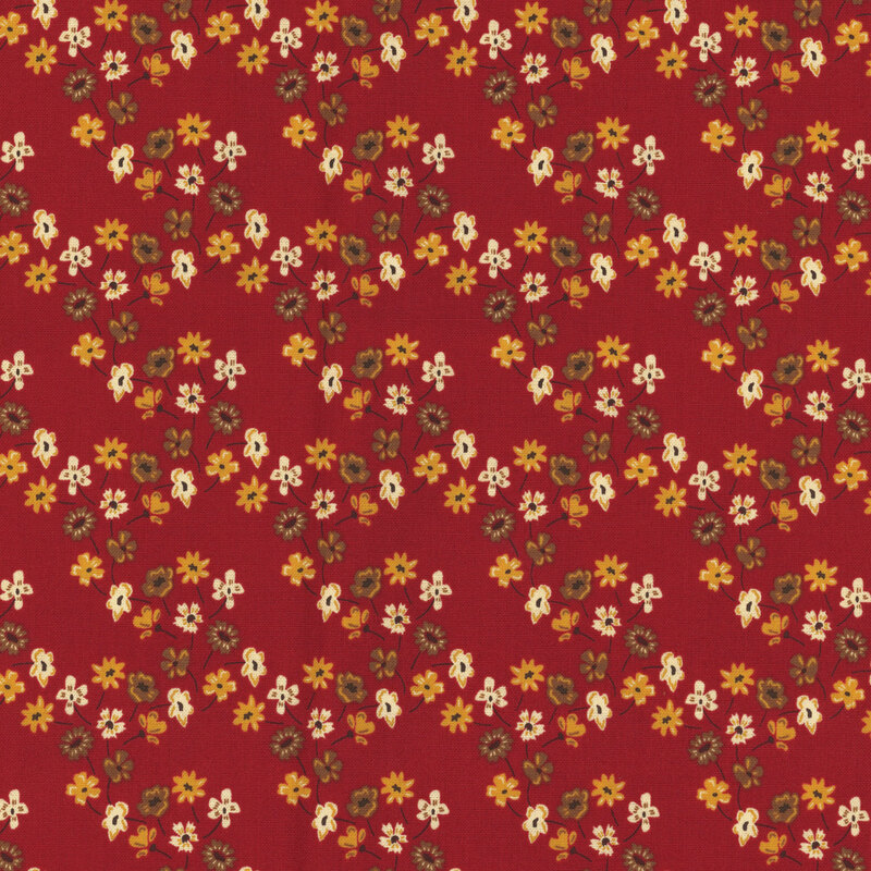 fabric with orange, yellow and red flowers forming a lattice across a red background