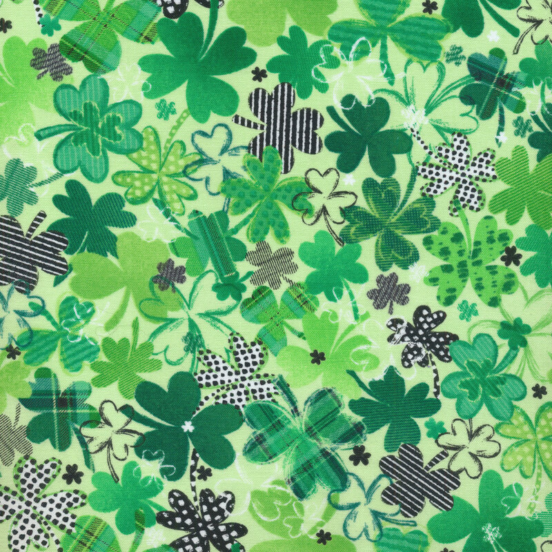 light green fabric covered in darker green and plaid shamrocks