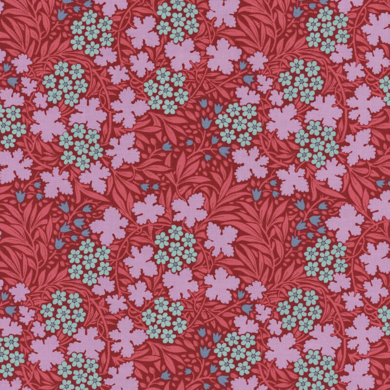 Hibiscus colored fabric with bright and medium pink leaves sprawled across it, accented by blue flowers