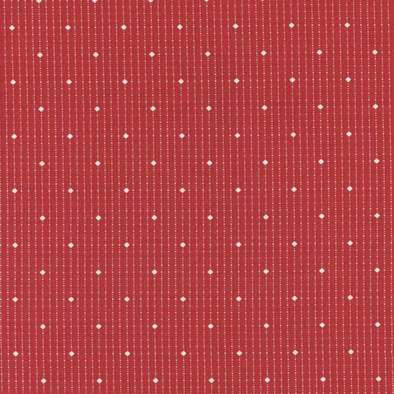 fabric with diamonds and dots in cream on a bold red background