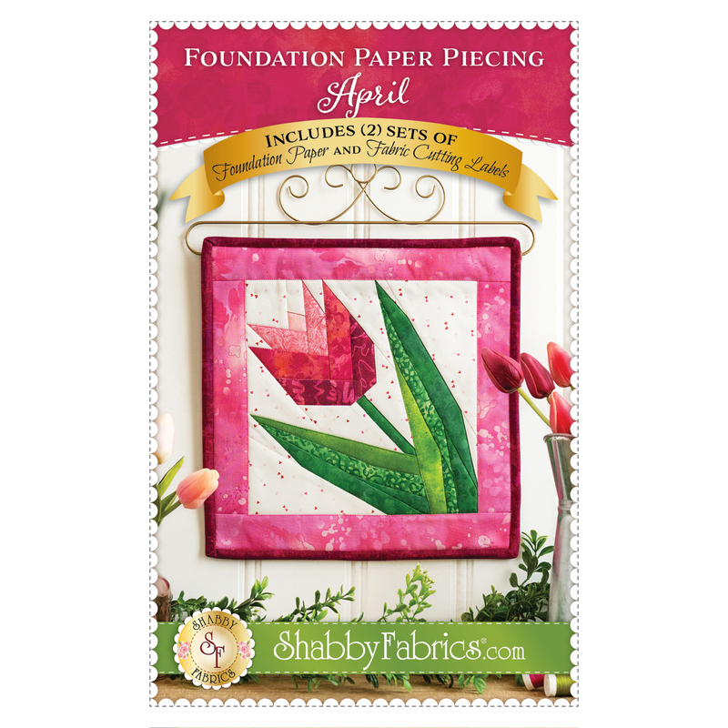 paper pieced tulip block in spring pinks hanging on gold curl craft holder