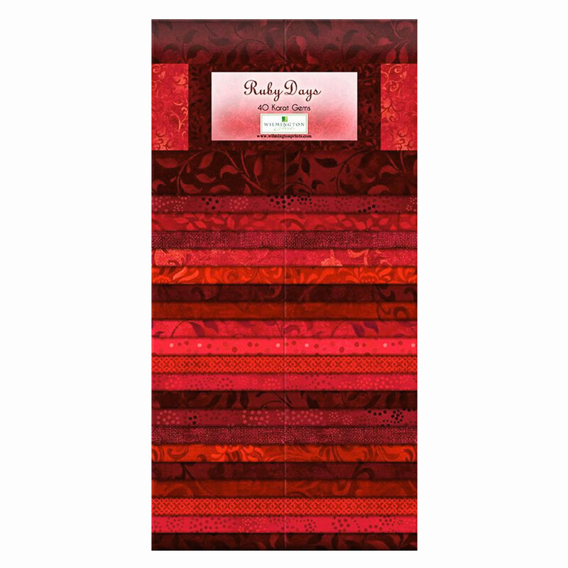 A pack of tonal ruby fabrics with various patterns layered and repeated with a label on the front
