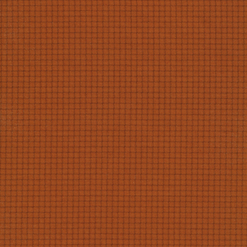 Dark rusty orange fabric with a small tonal grid pattern across it