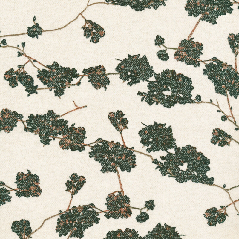fabric featuring green sprawling branches across a cream background