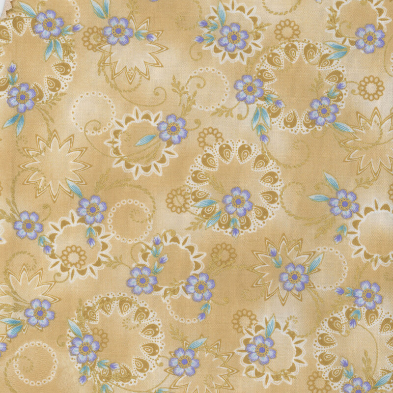 tan mottled fabric with light periwinkle flowers and gold metallic swirls