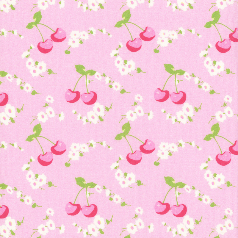 Bright pink fabric with bright pink cherries and white daisies across it