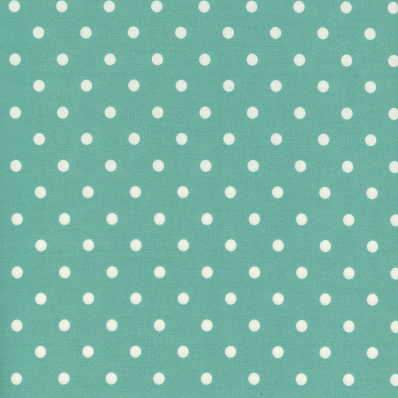 Bright teal fabric with white polka dots across it