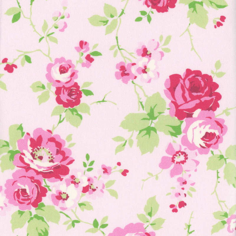 Light pink fabric with tossed bright pink roses and greens stems and leaves