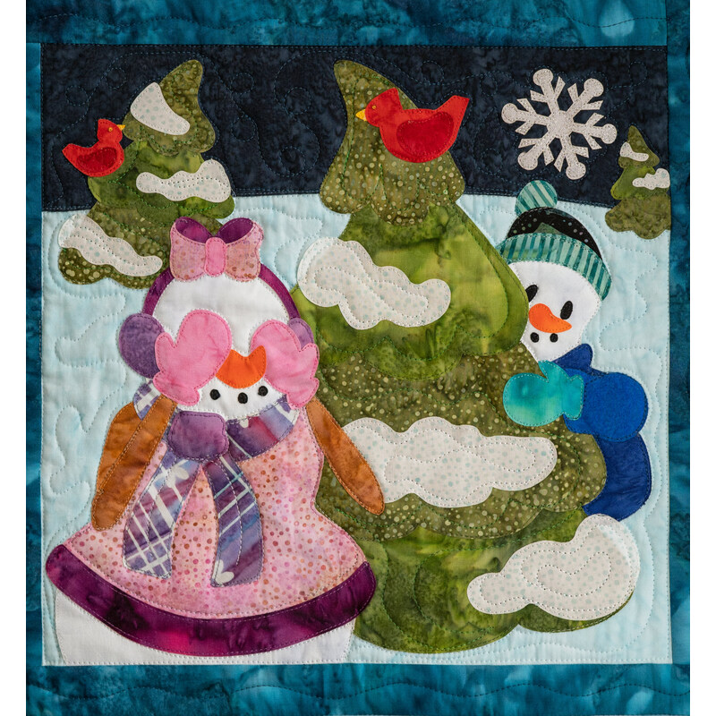 Quilted block depicting two snowmen in winter clothes playing hide-and-seek behind an evergreen tree with red cardinals perched in them